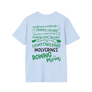 May include: Light blue t-shirt with green text that reads "uniform washing, fridge filling, practice carpooling, course side yelling, harmony loving, loud cheering, Wolverines, Rowing Mom."