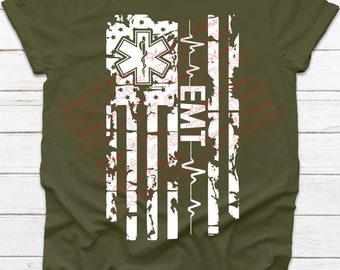 May include: A green t-shirt with a white distressed American flag design. The flag has a medical symbol and the text "EMT-W" on it.