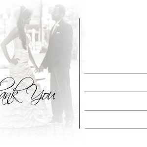 May include: A black and white postcard featuring a bride and groom holding hands. The bride wears a white wedding dress and veil. The groom is in a black suit. The words "Thank You" are written in elegant script.