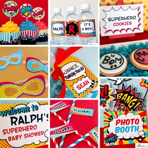 May include: A collection of superhero-themed party supplies including cupcake toppers with Pow, Wow, and Pow text, water bottle labels reading Ralph, R, and It's a Boy, superhero cookie signs, polka dot masks, thank you tags, and photo booth props.