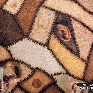 Close up of texture on handmade square pillow on wood floor made of minky fleece fabric featuring an original patchwork print of multiple shades of human skin and body parts stitched together including haunted faces, ears, elbows, and nipples.