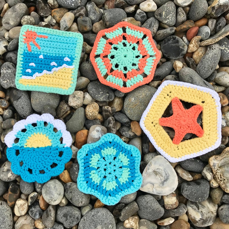 May include: A collection of six colorful, handmade crochet coasters. Designs include a beach scene, geometric patterns, and a starfish. The coasters are in shades of blue, yellow, orange, and white.