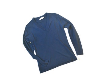 May include: A dark blue long-sleeved v-neck jumper.