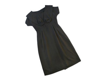 May include: A black dress with a large, folded collar and short sleeves. The dress has a fitted bodice and a slightly flared skirt.