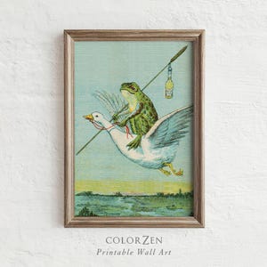 May include: A framed vintage print depicts a green frog riding a white goose, holding a long pole with a bottle. The artwork has a light blue background with a marsh scene at the bottom. The text "COLORZEN Printable Wall Art" is at the bottom.