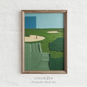 May include: A framed wall art print depicting a golf course with thick, textured green paint strokes representing the grass, tan sand bunkers, and small figures of golfers on the course under a light blue sky with a solid blue rectangular block.