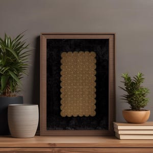 A cozy interior scene featuring printable wall art with a golden lace pattern framed in a modern wood frame. The artwork is set against a dark background, creating a warm and inviting atmosphere. Perfect for instant download, this piece enhances any living space.