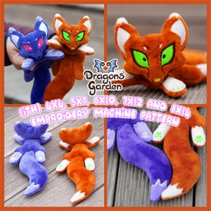 May include: Two plush fox toys, one orange and one purple, with white accents. The toys are lying on a wooden surface. The image includes the text "Dragons Garden (iTH) 4X4, 5X7, 6X10, 7X12 AND 8X14 EMBROIDERY MACHINE PATTERN".