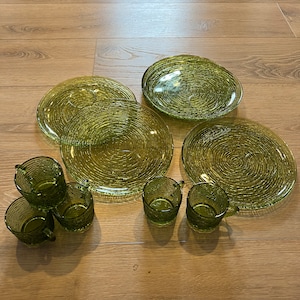 May include: Set of green glass plates and cups with a textured swirl design.