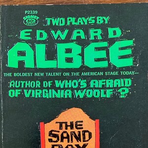 May include: A black and green book cover with the title "Two Plays by Edward Albee" and the text "The Sand Box" and "The Death of Bessie Smith".