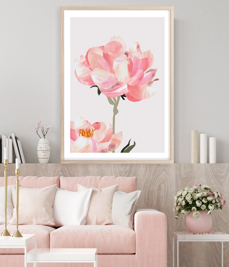 May include: A framed print of a pink peony flower with a white background. The flower is in focus and the background is blurred.