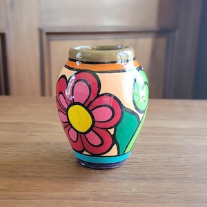 Jarrón de cerámica vintage pintado a mano, estilo arte popular — 8,25 cm, firmado por JJF, con estampado floral llamativo y detalles coloridos.