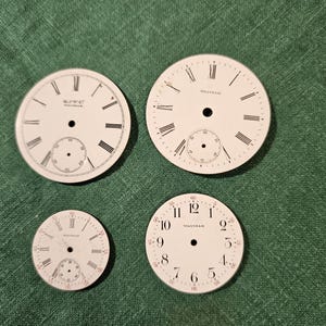 May include: Four vintage watch faces with white backgrounds and black Roman numeral markings. The top two faces are labeled "Waltham" and the bottom two faces are labeled "Waltham" with the text "55 60 11 12 1 10 9 8 7 6 5 30" around the outside.