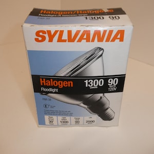 May include: A Sylvania PAR 38 halogen floodlight box. The box is white with orange and black text, and a graphic of the floodlight. The box indicates 1300 lumens and 90 watts.