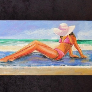 Painting of woman lying on beach towel in pink bikini/ rectangular gallery wrap canvas 4&quot; x 12&quot; painted on all sides, blue and aqua colors.