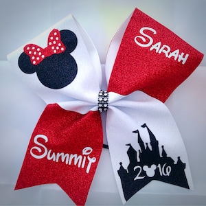 May include: Red and white cheer bow with black glitter. One side features a black silhouette of Mickey Mouse's head with red polka dot bow and the text "Summit". The other side features a black silhouette of Cinderella's castle with the text "Sarah" and "2016".