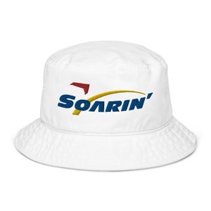 May include: White bucket hat with a blue, yellow and red embroidered logo that says "SOARIN'"
