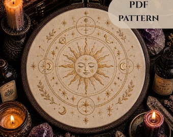 May include: A beige embroidery hoop with a sun, moon, and star design. The design is in gold thread and includes the text "PDF PATTERN". The image is surrounded by candles, crystals, and bottles.