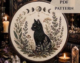 May include: An embroidery hoop containing a fabric panel with a black cat centered among embroidered wildflowers and a moon phase cycle above. The text PDF PATTERN is visible in the upper right corner of the image, set against a dark background.