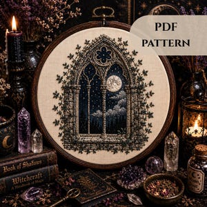 May include: An embroidery hoop containing a fabric panel with a detailed needlework design of a gothic stone window arch at night. The scene features a full moon, starry sky, and climbing vines. The text PDF PATTERN is visible in the upper right.