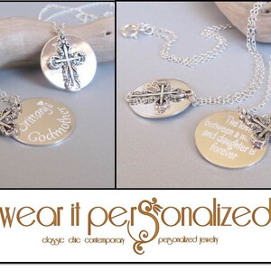 May include: Two silver necklaces with cross pendants and engraved round charms. One charm reads "Brittany's Godmother" and the other reads "The love between a mother and daughter is forever."