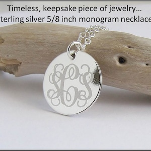 May include: Sterling silver necklace with a 5/8 inch round pendant featuring a monogram. The pendant is engraved with a script font.