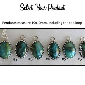 May include: Six oval-shaped pendants with a silver setting and green and blue gemstone. The pendants measure 19mm by 10mm, including the top loop. #1 #2 #3 #4 #5 #6