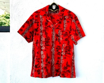 May include: Red short-sleeved button-up shirt with a tropical print of palm trees and flowers.