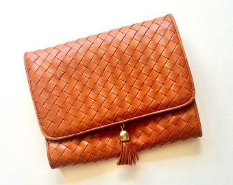 Sac bandoulière vintage années 90 en cuir tressé noir à pompon.