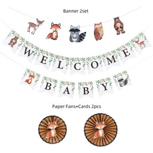 May include: Two white banners with green leaves and woodland animal illustrations. The top banner says "WELCOME" and the bottom banner says "BABY". Two brown paper fans with a fox illustration.