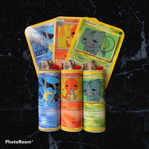 May include: Three lighters featuring Pokemon character designs. The lighters are decorated with images of Squirtle, Charmander, and Bulbasaur. Each lighter has a different colour scheme and features a different Pokemon move. The lighters are all in a vertical orientation.