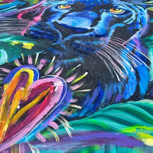 May include: A colorful abstract painting featuring a black panther with blue fur and a bright pink heart. The background is a mix of green, blue, and purple.