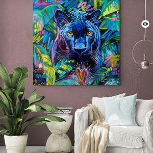 May include: A black panther with yellow eyes is painted in a vibrant, colorful style. The panther is surrounded by green, blue, and pink foliage. A pink heart is painted in the foreground.