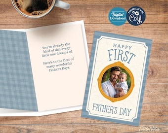 May include: A Father's Day card with a photo of a father and child inside a gold frame. The card reads "Happy First Father's Day" in blue text. The open card has a blue plaid pattern on the left side and text that reads "You're already the kind of dad every little one dreams of."