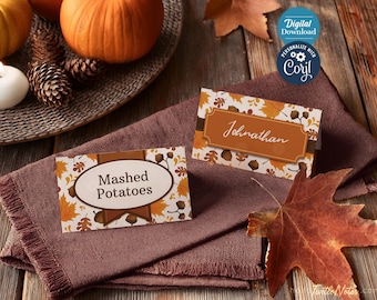 May include: Two printable Thanksgiving place cards with a fall leaf design. One card says "Jonathan" and the other says "Mashed Potatoes".