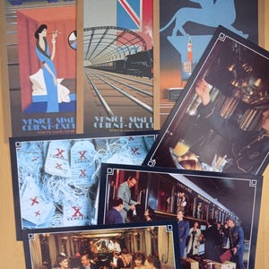 May include: A collection of vintage travel posters and photographs. The posters feature stylized illustrations of Venice and train stations, with text including "Venice Simplon Orient-Express." Photographs depict scenes inside a train and luggage tags.