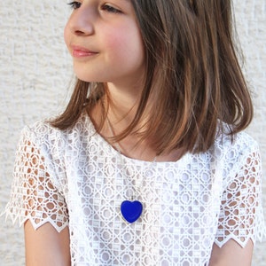 Lapis blue heart pendant necklace, made of resin, with a silver tone base. Show your love with this beautiful heart charm
