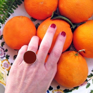 Burgundy big round ring, made of resin, with a hammered silver band. An elegant dark red statement ring