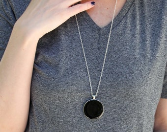 Onyx black big round silver tone pendant necklace, made of resin. Monochrome & minimal, a contemporary necklace for everyday wear