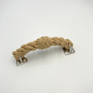 May include: A natural rope door handle with a knotted design and silver metal mounting plates.