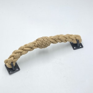 May include: A natural rope door handle with a knotted center and black metal mounting plates.