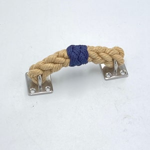 May include: A beige rope handle with a navy blue accent, attached to two silver metal plates with screws.