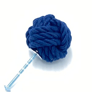 May include: A navy blue rope knob with a silver screw. The knob is tied in a knot and is a decorative hardware piece.