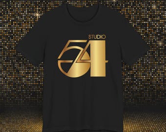 May include: A black short-sleeved t-shirt featuring a metallic gold graphic on the chest. The design displays the text STUDIO above the large stylized numbers 54, rendered in a bold, geometric font with a gradient gold finish and sharp lines.