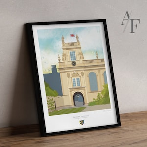 May include: A framed illustration of Trinity College, Cambridge, England. The illustration depicts the front of the building with a large arched doorway and a clock tower. The building is painted in shades of beige and cream with a green lawn in front. The image is titled "Trinity College" and includes the college crest.