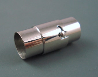 May include: A silver magnetic clasp for a bracelet or necklace. The clasp is made of two pieces that snap together.