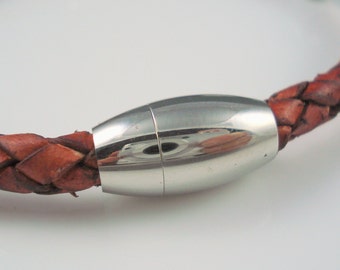 May include: A brown leather bracelet with a silver magnetic clasp.