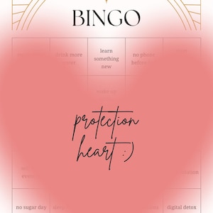 May include: A self care bingo card with a large, soft-focus pink heart overlaying the centre. The card features gold line art at the top and bottom, with text including "SELF CARE", "BINGO", and "protection heart :)" written in the centre.
