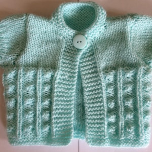 Knitting Pattern no 50 PDF to knit a baby girls cardigan bolero short sleeved cardigan, in 5 sizes from newborn to 12 months.