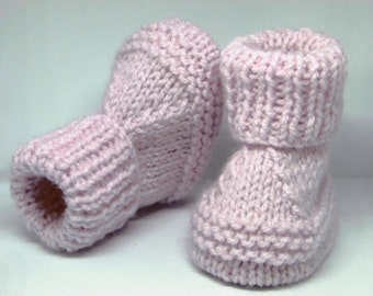 May include: A pair of pink knitted baby booties with a fold-over cuff. The booties are made with a simple knit stitch and have a soft, cozy feel.